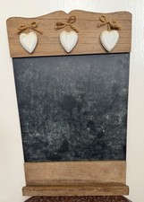 Farmhouse/country cottage style chalkboard with three Wooden hearts.