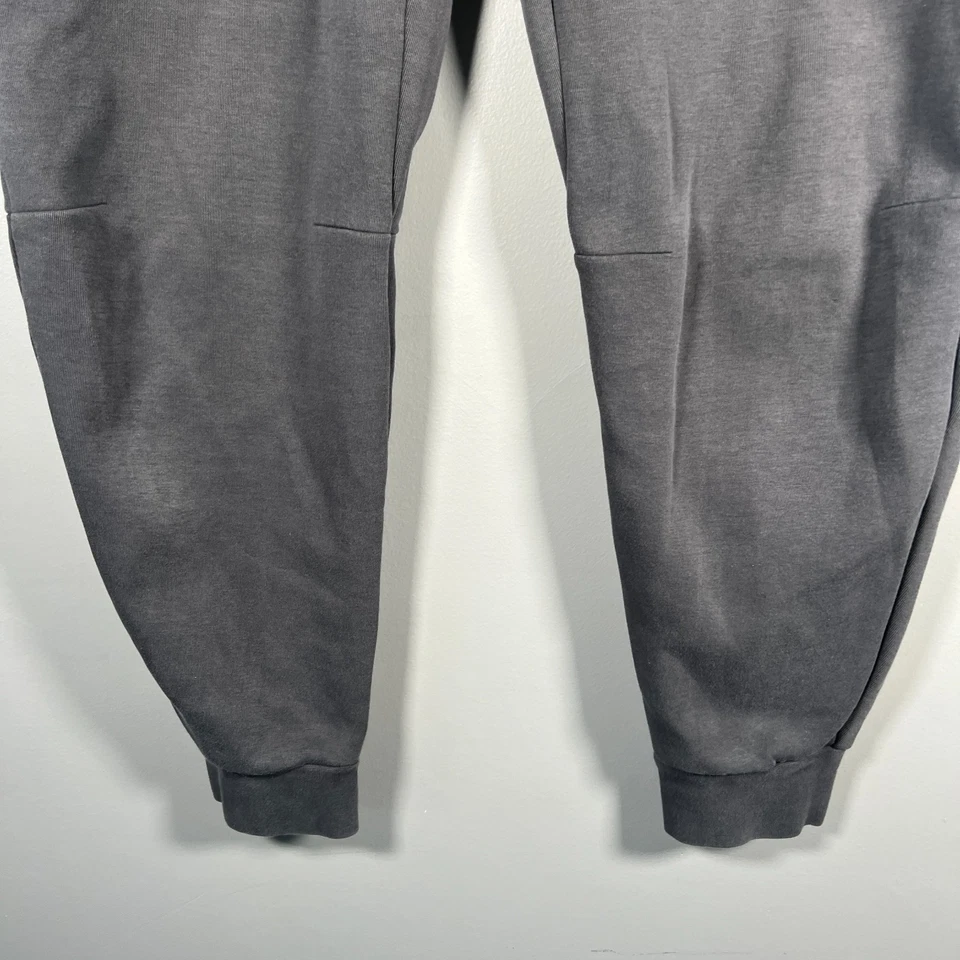 Pantalones de chándal Nike Tech polar para hombre gris oscuro medio ropa deportiva naranja Foto 3 de 4