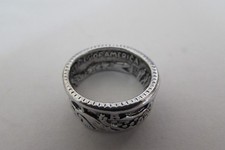 NEW/pkg size 10 ring made out of a half dollar coin - see inside markings