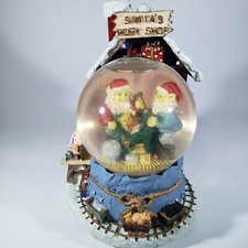 Snow Globe Santas Workshop plays music lights up takes 2 AA batteries
