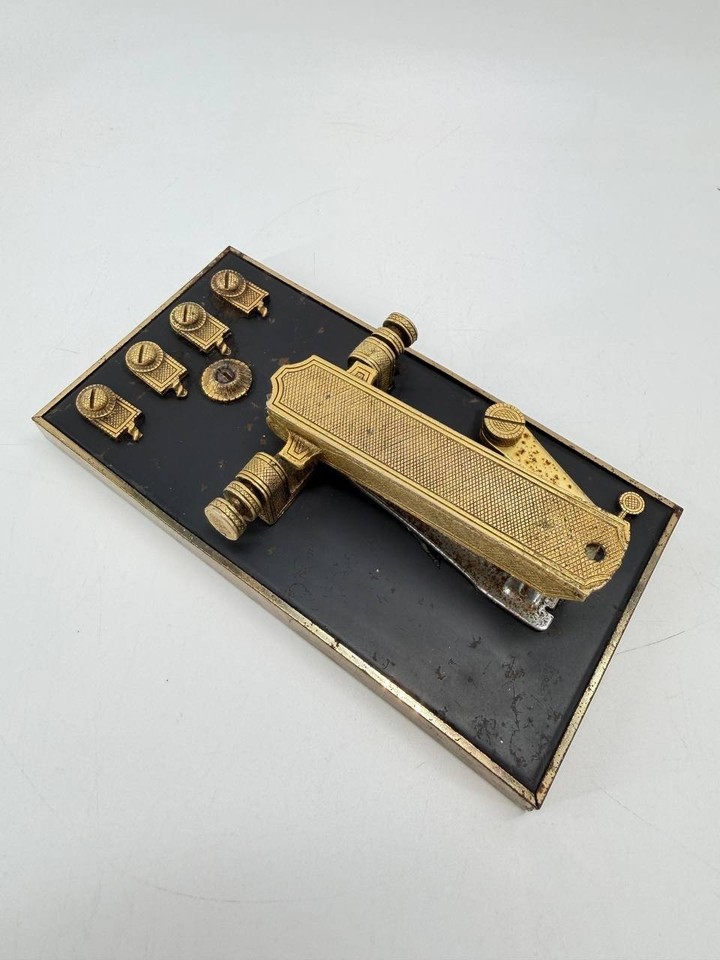 A gold-tone velvet-based mid-century stapler set that makes office supplies look like jewelry — Mad Men props come to life.