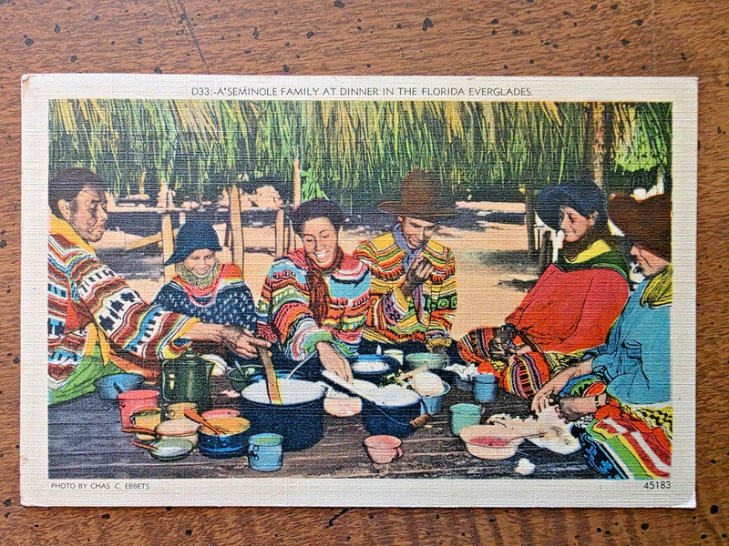 LINEN POSTCARD VIEW OF SEMINOLE FAMILY AT DINNER IN THE FLORIDA EVERGLADES, 1942