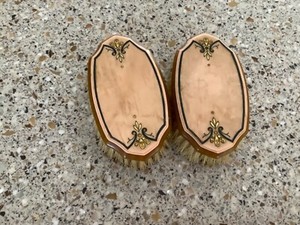 Vintage pair of inlaid bakelite grooming brushes