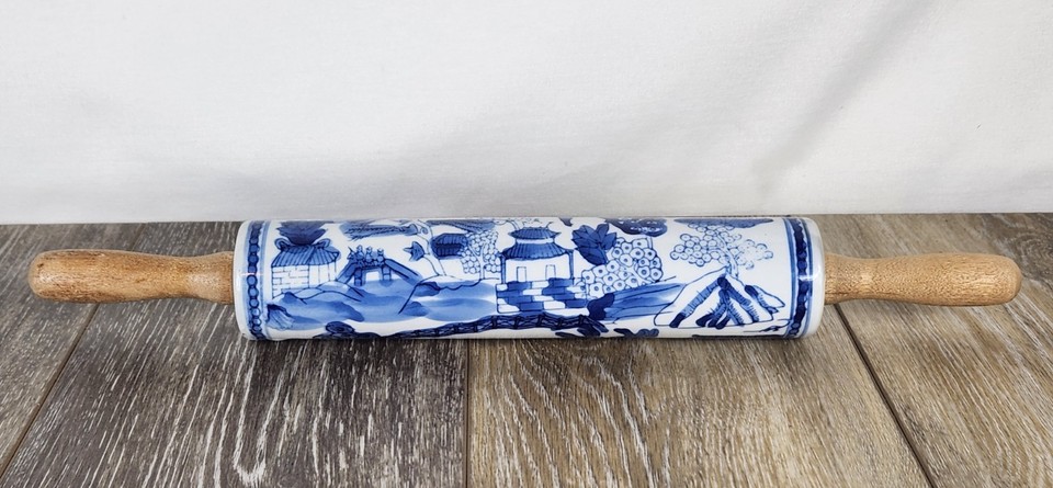 A porcelain and wood Blue Willow rolling pin — the iconic blue-and-white chinoiserie pattern on a functional baking tool is genuinely stunning and display-worthy.