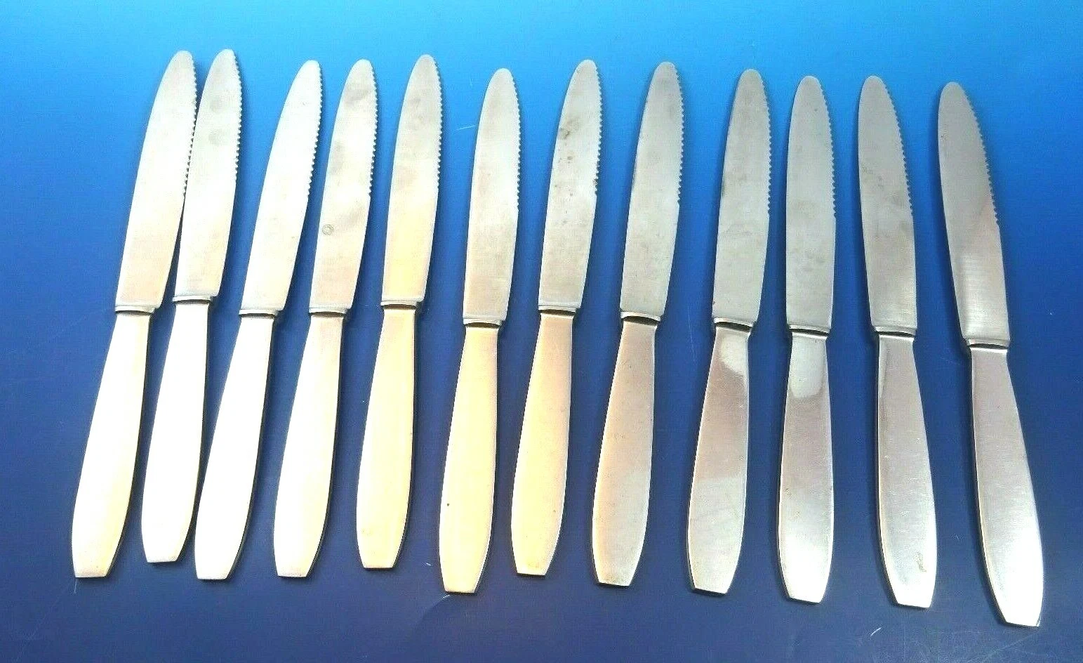 Group of 12 French Stainless Steel Modernistic Flat Handle Serrated Knives #3579