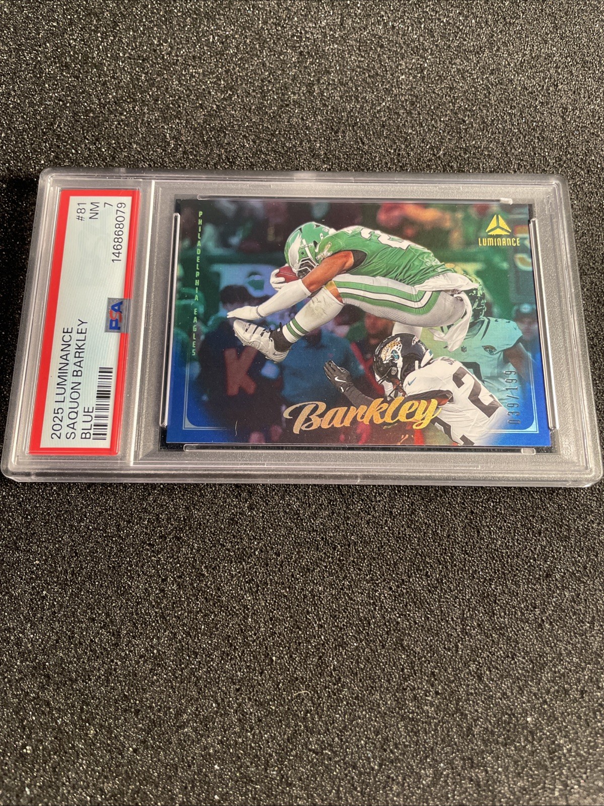 2025 Panini Luminance - Saquon Barkley #81 Blue /199 PSA 7 Iconic hurdle view 2
