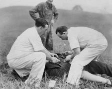 John Stewart receiving first aid from Dr Nick Cosco and James Duvo .. Old Photo