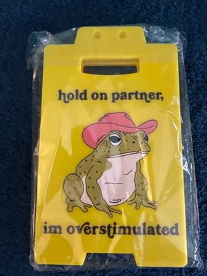 funny caution sign with frog wearing a pink cowboy hat 