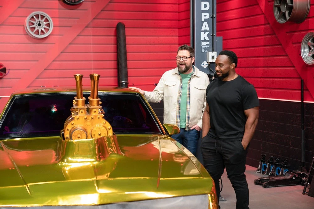 Hot Wheels: Ultimate Challenge: Rutledge Wood and WWE Superstar Big E admire the "Mardi Gras Mania" Monte Carlo.
