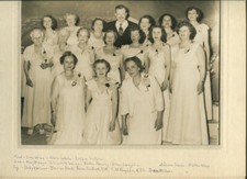 GROUP PHOTO, MANY WOMEN AND ONE MAN. WOMEN WITH CORSAGES, MAN WITH MUSTACHE.