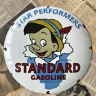 VINTAGE STANDARD GASOLINE DISNEY PINNOCHIO 12 INCH CONVEX PORCELAIN ENAMEL SIGN