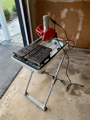 Husky wet saw ( 7 In. Wet Tile Saw w/ Laser and Stand ) - $275