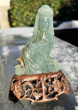 A rare 19th century Chinese Carved Jadeite Guanyin & Wood Stand