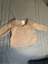 This is a Baby Gap baby Sweater made of 65 cotton, 20 wool, and 15 nylon.
