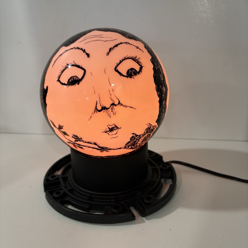 A vintage plastic globe lamp with three moon faces in full pop-art kitsch glory — the kind of accent piece that stops guests mid-sentence.