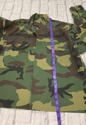 Vintage green camouflage Ranger shirt, USA made, with chest pockets and measuring tape along the collar.