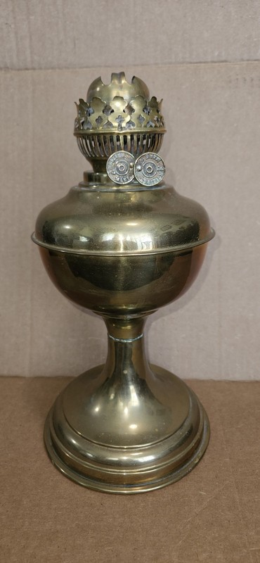 Vintage brass kerosene oil lamp  featuring a compressed font and weighted base