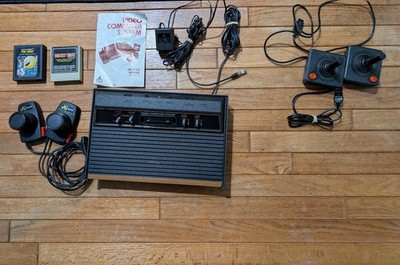 Atari CX2600A Console, two sticks, two paddles, and two games. Tested & Working!