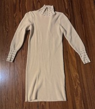 Cream or ivory ribbed knit sweater dress with a mock neck and beaded details on