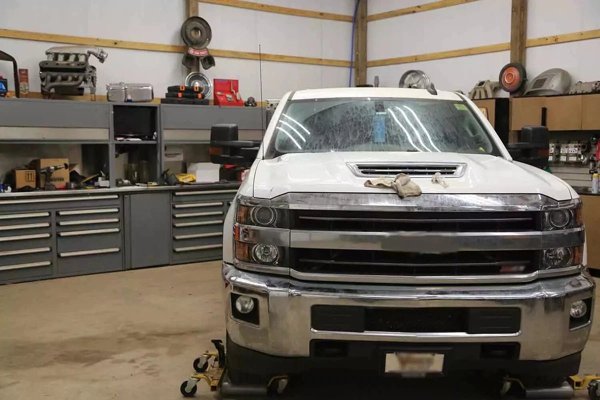 A pickup truck parked in a shop with a concrete floor.