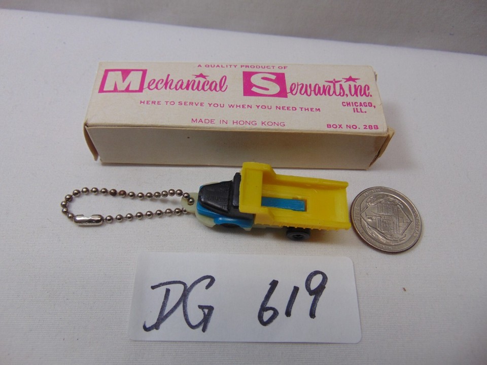 Tiny Hong Kong-era mechanical dump truck keychain puzzle — a genuine relic of novelty toy engineering you can't find at any store.