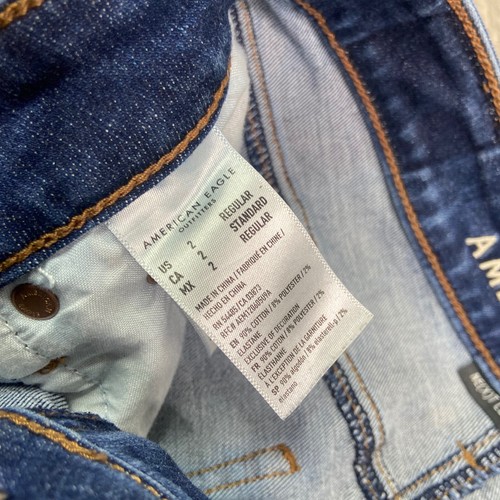 Pantalones de mezclilla ajustados elásticos American Eagle Next Level 2 dobladillo crudo desgastado azul - Imagen 10 de 10
