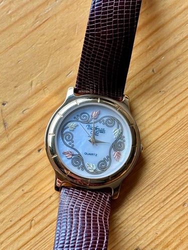 BLACK HILLS GOLD LADIES QUARTZ WRISTWATCH 12K TRI COLOUR LEAF, MOP DIAL, WORKING