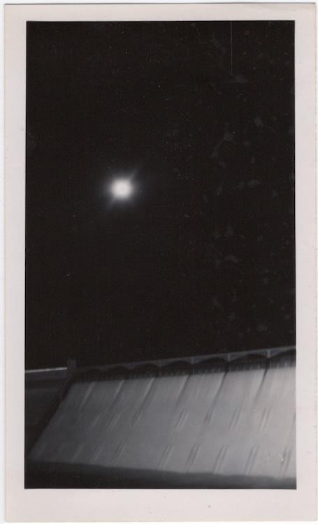 Hazy moon over dam spillway, 1940s