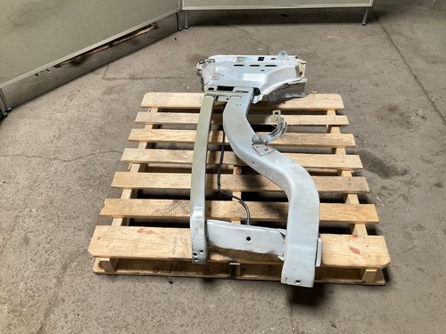 Silver 13-18 RAM 1500 front left driver frame apron radiator support with bent-up design on concrete pallet.