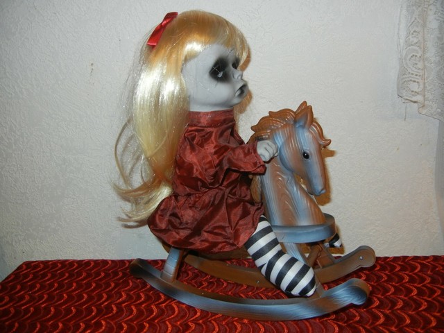 creepy doll on rocking horse