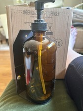 New In Box Glass Amber Bottle Soap Dispenser With Wall Attachment For Shower