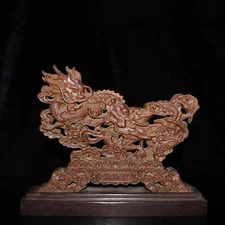 Handmade carved natural cliff cypress with a base and hollowed out dragon