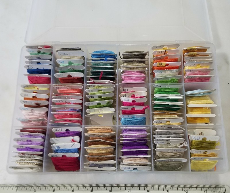 Organized Embroidery Floss Stash with Labeled Bobbins in Plastic Storage Case