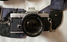 Olympus OM-2 SLR Film Camera with 50 mm lens carrying case and additional lenses