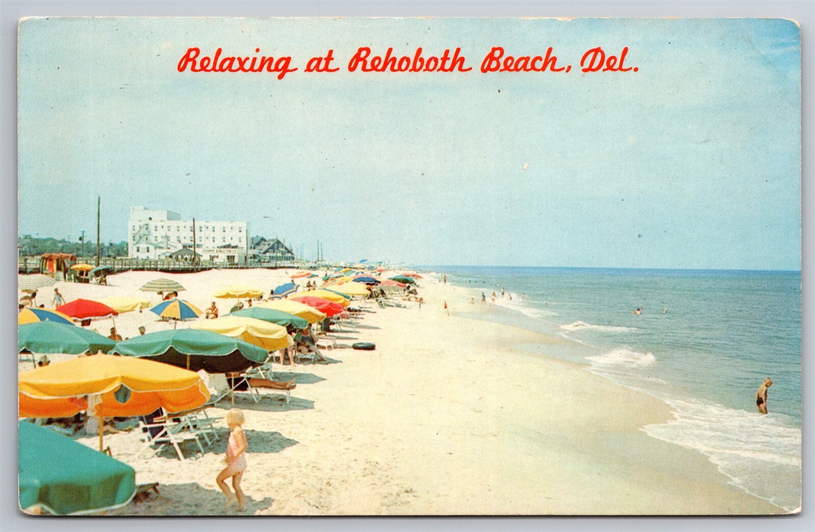 Explore Rehoboth Beach Delaware with Sandy Shores Sun Sea Surf Swim Umbrellas Postcard J10 for a Coastal Getaway