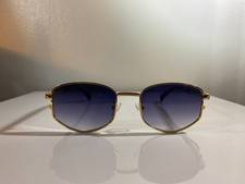 Unisex, gold wire framed black accents sunglasses with purple lenses.