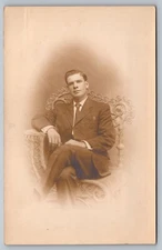 Postcard Studio Portrait Man Sitting On Wicker Photographers Chair RPPC