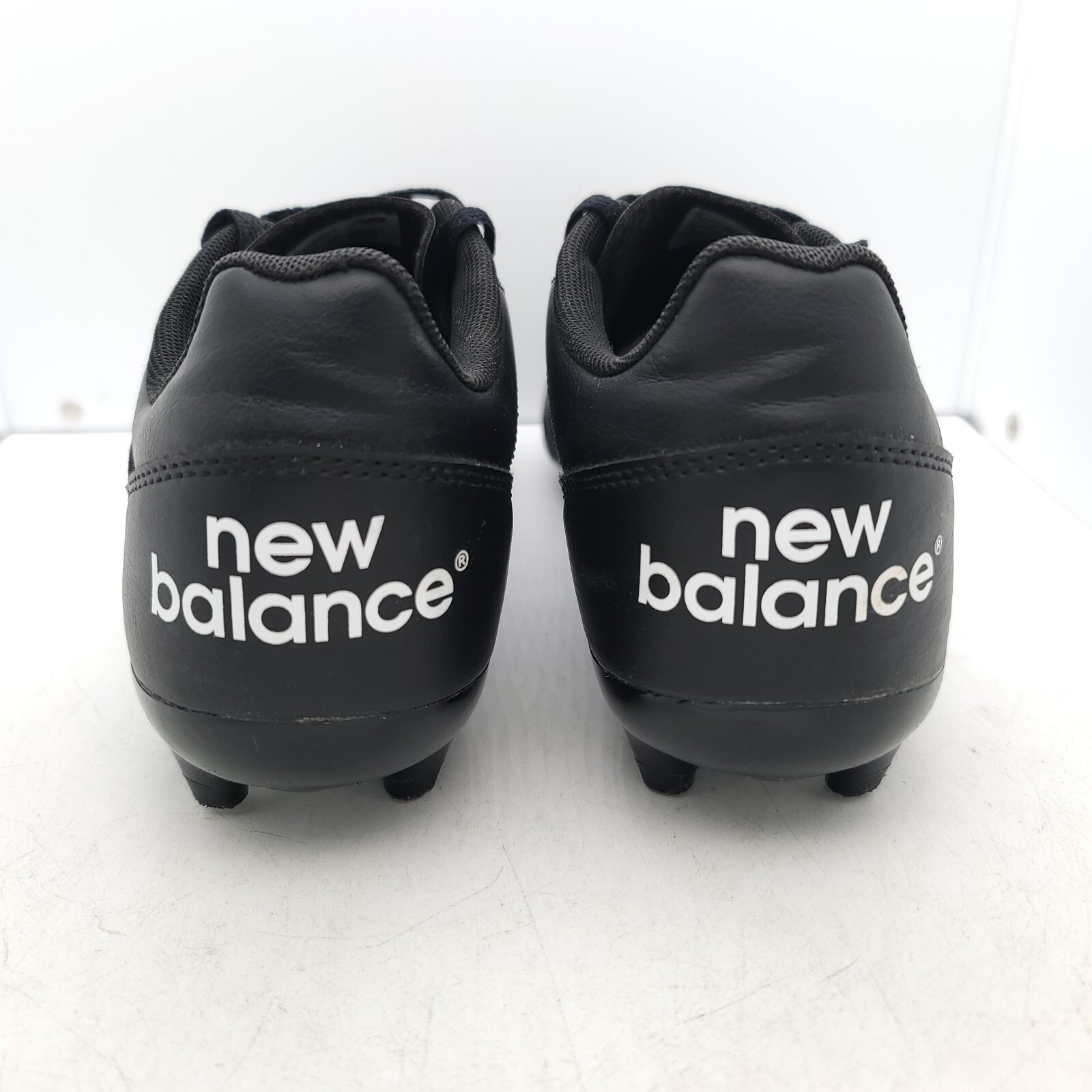all black new balance football boots