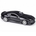 Black alloy 1:24 Aston Martin Valour diecast car model with silver wheels, side spoiler, and visible white interior.
