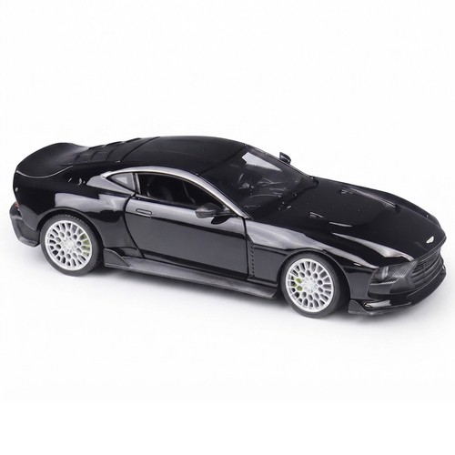 Black alloy 1:24 Aston Martin Valour diecast car model with silver wheels, side spoiler, and visible white interior.