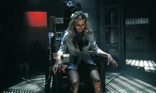 BEYOND RE-ANIMATOR DVD cover: woman in white blouse on metal chair, surrounded by zombie spider emblems.