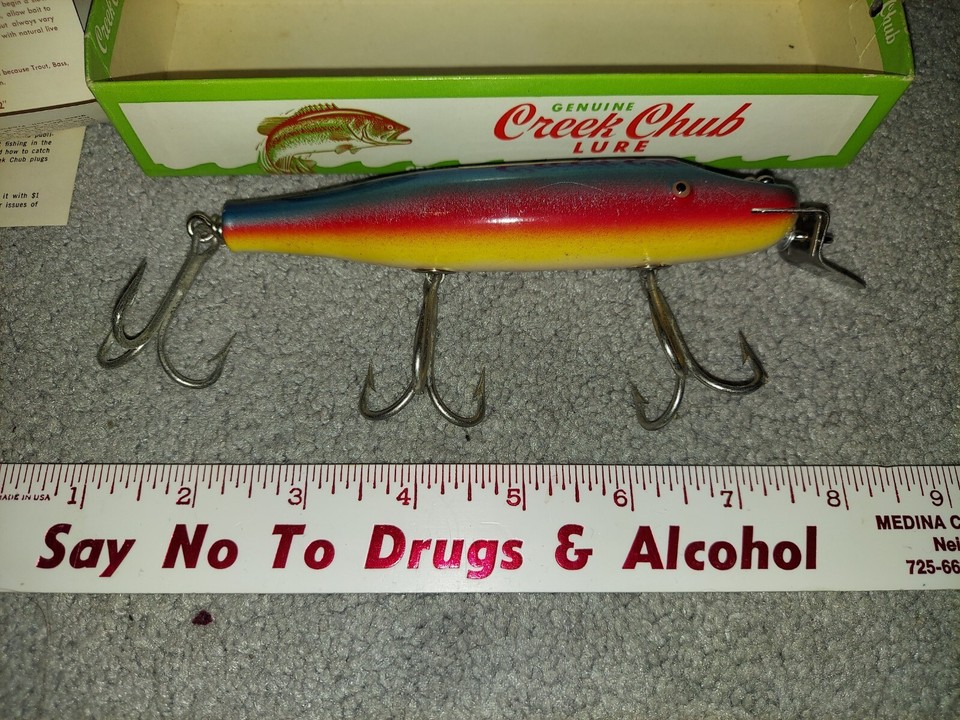Selection of vintage fishing items including two boxed Creek Chubs C.C.B. Co. Lures by Allcock, La