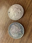 2 silver dollar coins: 1882 morgan silver dollar, 1923 peace silver dollar