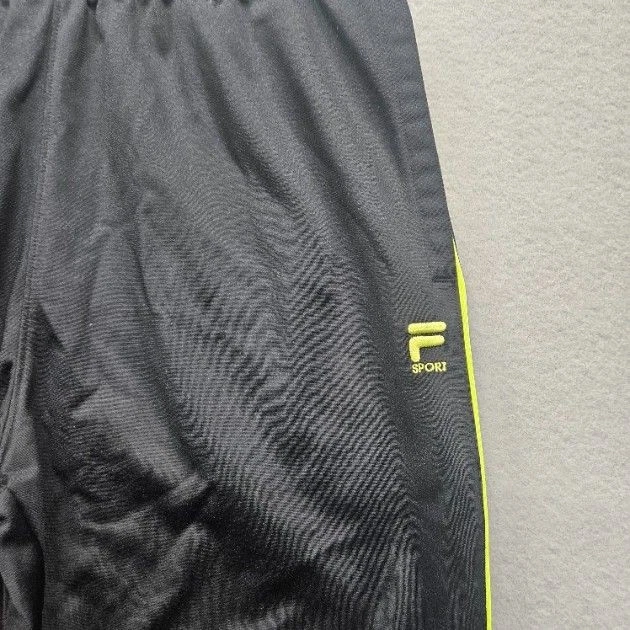 Pantalones deportivos Fila para hombre talla mediana negros amarillos neón pista deportiva Foto 2 de 4