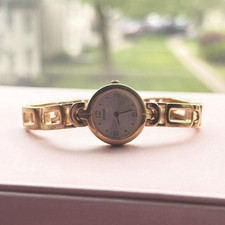 GUESS Women s Gold-Tone Bracelet Quartz Analo...