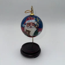 1997  Dillard's Trimmings Inside Painted Glass Christmas Ornament Les Han Stand