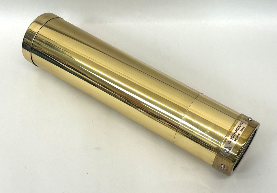 A named 13" brass kaleidoscope from Austin Texas artisan Peach Reynolds — a real signed craft piece, not a mass-market trinket.