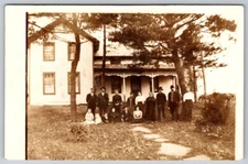 Large Family Posing for a Picture Outside Their Residence Home RPPC Postcard