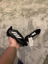 Black and white kids adidas goletto soft ground football boots