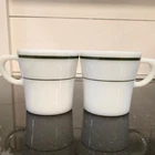 Vintage Pyrex Restaurant Ware milk glass mugs featuring dark green stripe bands